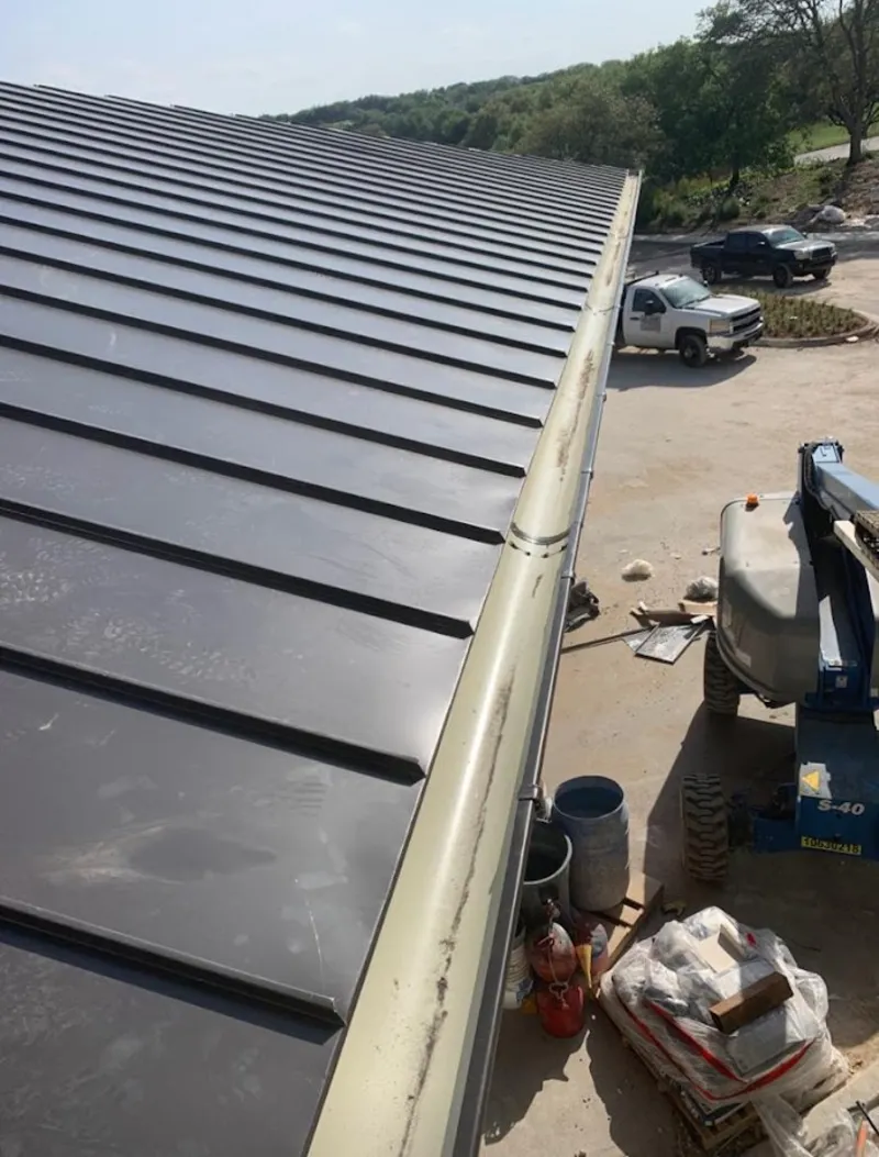 Standing seam panel and gutter detail on a metal roofing jobsite in Countryside